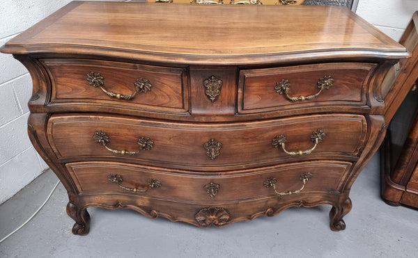 Impressive French Louis XV style Cherrywood four drawer commode, with a wooden top, two large drawers and two smaller drawers. Features attractive handles and a carved skirt and feet. In good original detailed condition.