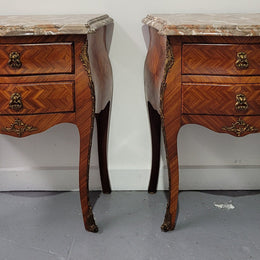 Pair of Louis XV commode style two drawer bedsides with beautiful marble tops and decorative mounts. They are a rare size and are in good, detailed condition.