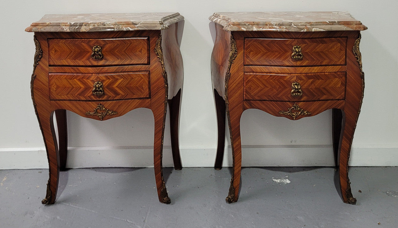 Pair of Louis XV commode style two drawer bedsides with beautiful marble tops and decorative mounts. They are a rare size and are in good, detailed condition.
