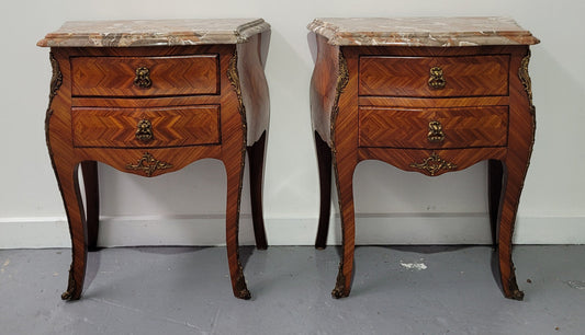 Pair of Louis XV commode style two drawer bedsides with beautiful marble tops and decorative mounts. They are a rare size and are in good, detailed condition.