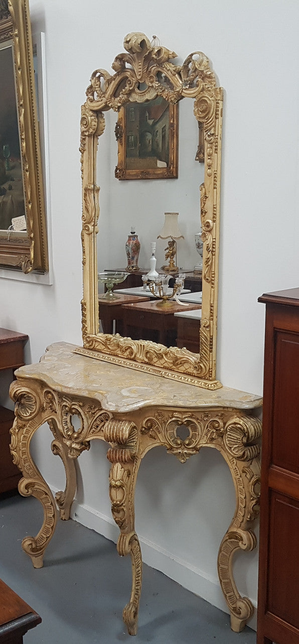 Beautifully carved Italian Rococo style painted console/hall table and mirror. An amazing coloured marble top showing sections of gold veins and is in good condition. Mantle mirror is retaining it's original mirror and showing ages spots.