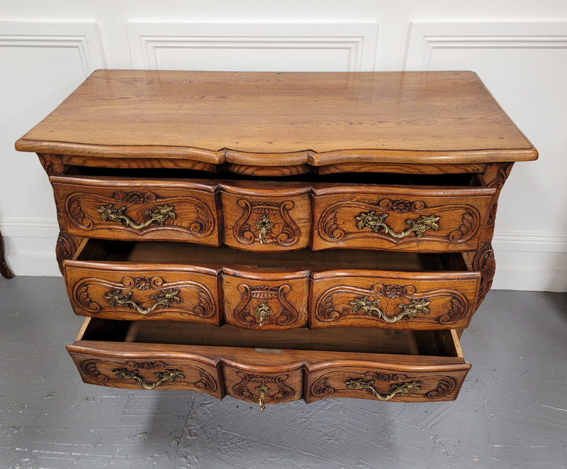 French Antique Louis XIV style Oak wooden top commode. It has a stunning serpentine bombe shape front along with amazing handles and carvings. It comes with three beautiful keys as pictured and comes with working locks. It has been sourced from France and in good original detailed condition.