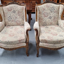 Lovely French pair of gilt and floral upholstered Bergere chairs with beautiful decorative carving. Fabric is in good original condition and chair has been detailed.