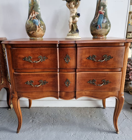 Elegant French Louis XV style Cherrywood commode with two drawers. It is in good original detailed condition.