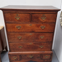 Early 19th Century English Oak chest on stand. It has been sourced in France and has plenty of storage space with eight drawers. In good original detailed condition.