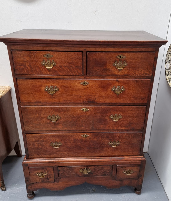 Early 19th Century English Oak chest on stand. It has been sourced in France and has plenty of storage space with eight drawers. In good original detailed condition.