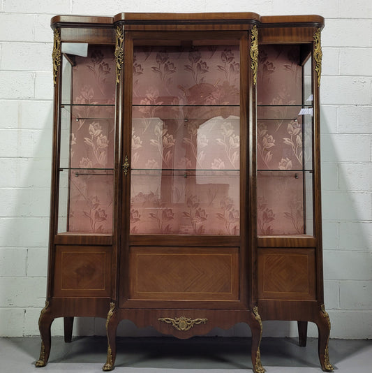 Beautiful French Louis XV style large walnut display cabinet with lovely ormolu mounts . There are two glass shelves and has its original dusky pink fabric in good condition.