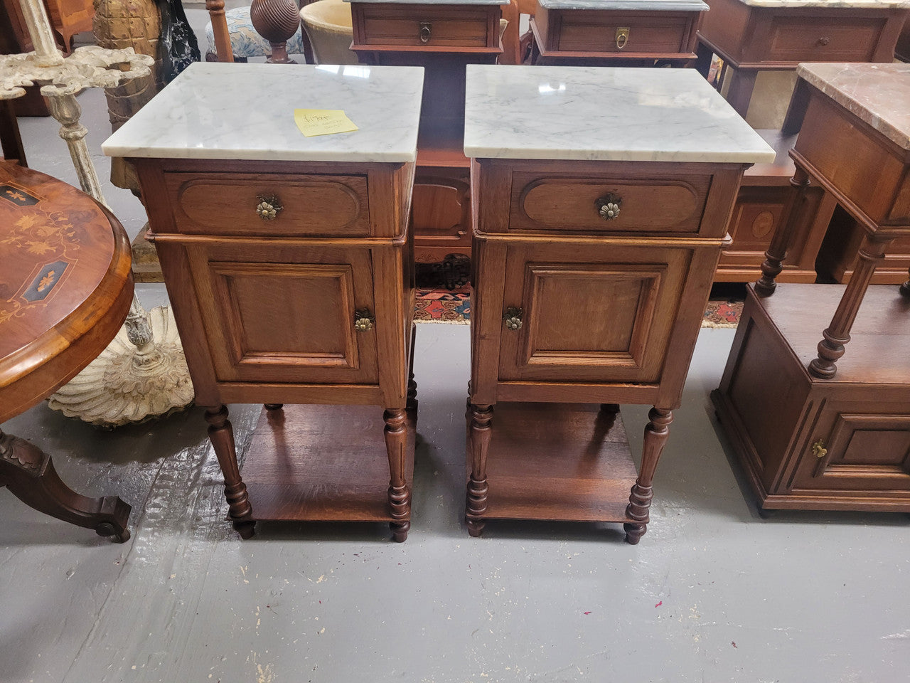 Antique French Oak Henry II white marble top bedside cabinets. They have one drawer and cupboard a long with an open shelf at the bottom. Sourced from France and in good original detailed condition.