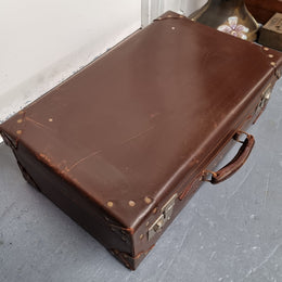 Impressive solid leather suitcase, moire fabric lined with leather straps to hold contents. Displays gold initials F.S.A near handle. With key. Please view photos as they help form part of the description.