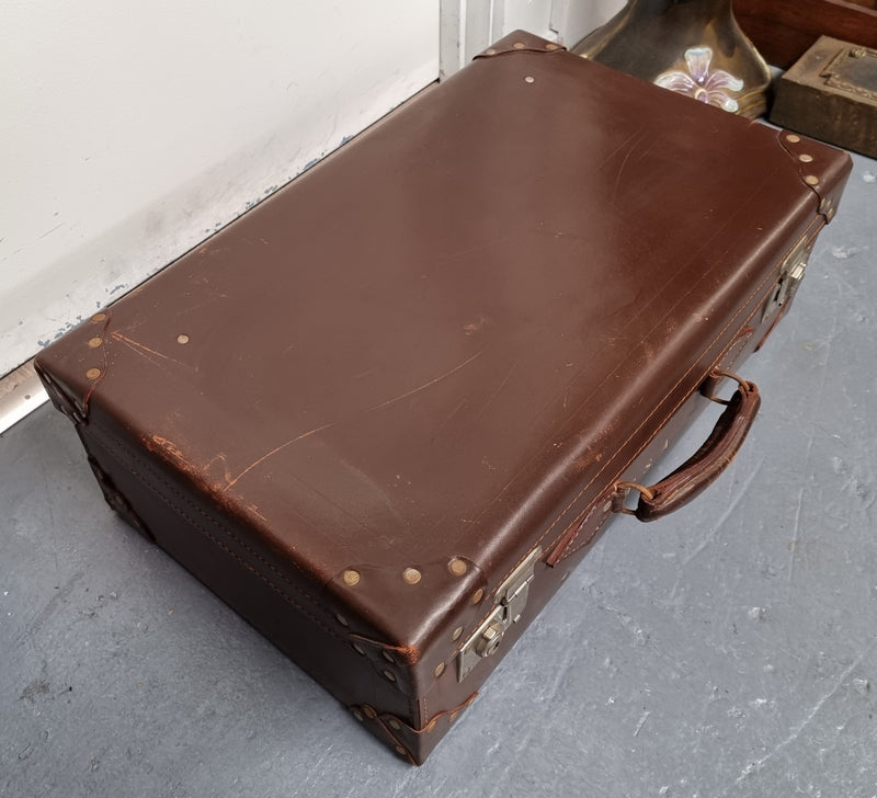 Impressive solid leather suitcase, moire fabric lined with leather straps to hold contents. Displays gold initials F.S.A near handle. With key. Please view photos as they help form part of the description.
