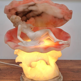 A superb original hand carved Art Deco lamp. Alabaster and marble sculpture of a nude woman inside a clam shell. Italian, inscription to base. Circa 1920's. Subtle colouring to clam shell for a sunset effect. This is a world class example of a true Art Deco sculpture lamp. It is in good original detailed condition, please view photos as they help form part of the description.