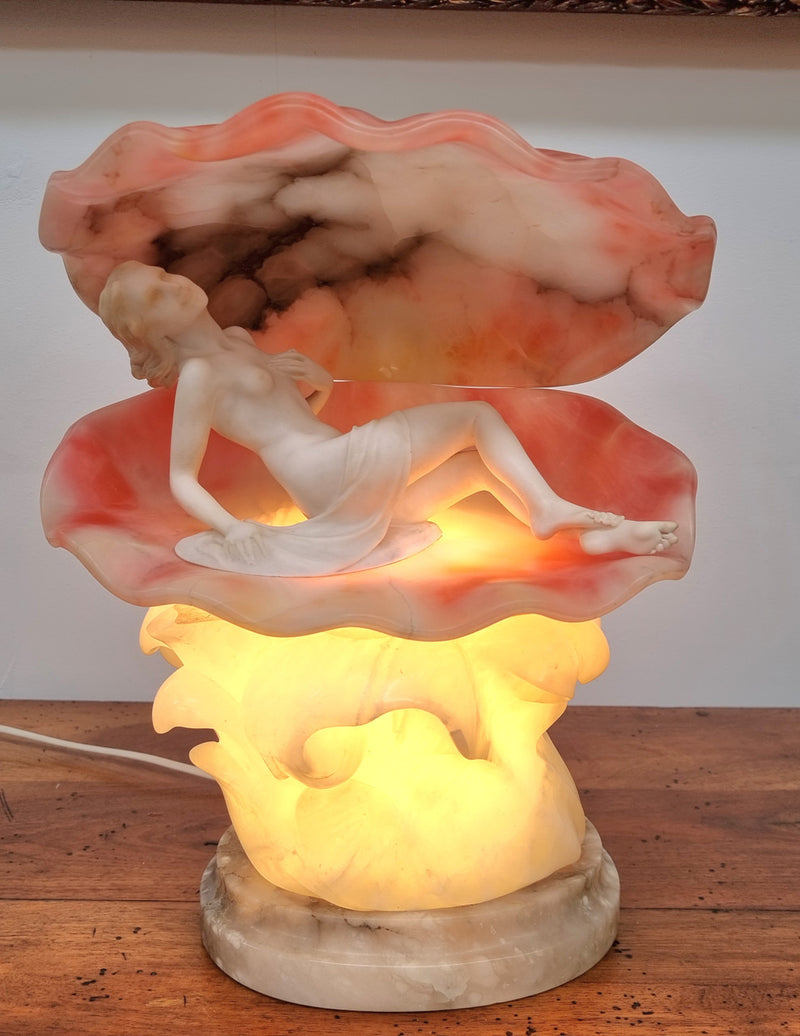 A superb original hand carved Art Deco lamp. Alabaster and marble sculpture of a nude woman inside a clam shell. Italian, inscription to base. Circa 1920's. Subtle colouring to clam shell for a sunset effect. This is a world class example of a true Art Deco sculpture lamp. It is in good original detailed condition, please view photos as they help form part of the description.
