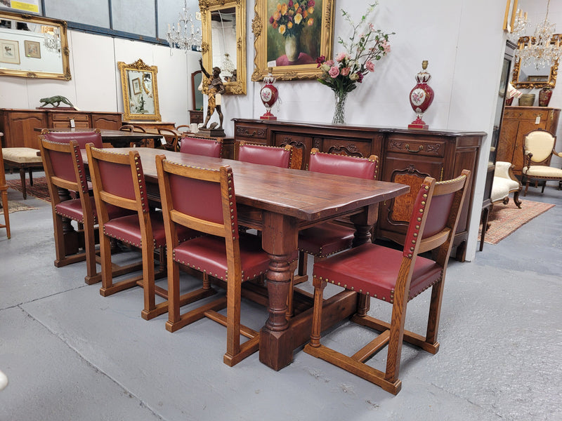 Charming solid rustic Oak stretcher base Farmhouse table. The table is circa 1950's and was custom made using reclaimed oak. It comfortable sits eight and could seat 10. It is in good original detailed condition.