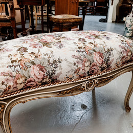 Antique painted Louis XV style upholstered stool. It has lovely floral upholstery that is in good condition with no tears. It is in good original detailed condition.