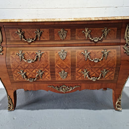 A beautifully inlaid parquetry three drawer commode with a lovely marble top, and decorative ormolu mounts. In good original detailed condition. Circa 1930