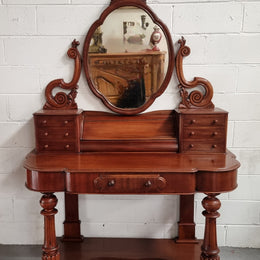 Victorian Mahogany duchess dressing table with tilt mirror on scrolled supports. It has seven trinket drawers and lift up storage. It is in good original condition and has been sourced locally.