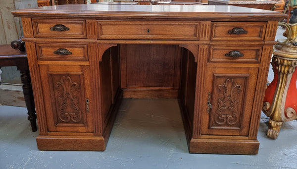 Lovely French Oak carved desk with four drawers and two cupboards. It is in good original detailed condition.