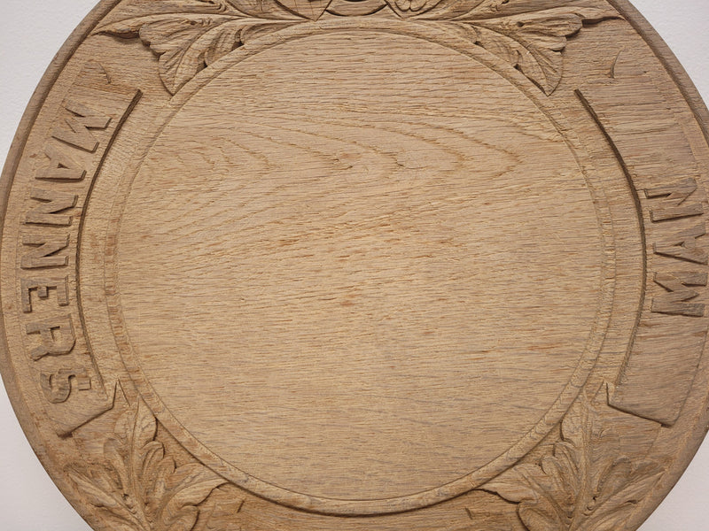 Antique circular Oak bread board carved with “Manners Makyth Man” and the arms of Winchester College England. It is in good original condition, please view photos as they help form part of the description.