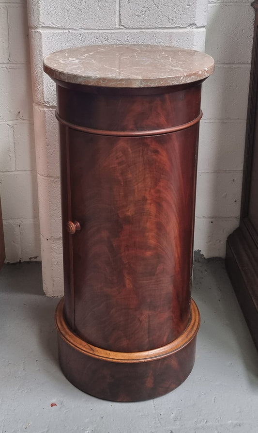 Unusual Empire flame Mahogany cylindrical marble topped bedside/pedestal. Would make an ideal pedestal with added storage inside or could be used as a bedside. Sourced from France and is in good original detailed condition.