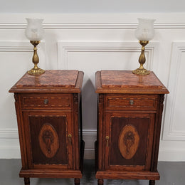 Pair of French Art Deco Oak and rouge inset marble top bedside cabinets. They have one drawer and one cupboard with elegant carving on the door. They have been sourced from France and are in good original detailed condition.