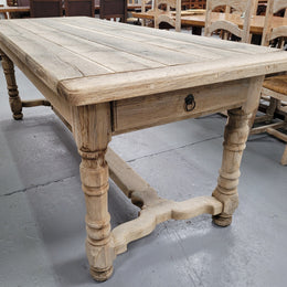 French stripped Oak pedestal stretcher base Farmhouse table with two drawers on either side of table. Features raw wood that could be used as is for a distressed look, or finished and waxed for a more refined look.
