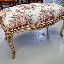Antique painted Louis XV style upholstered stool. It has lovely floral upholstery that is in good condition with no tears. It is in good original detailed condition.