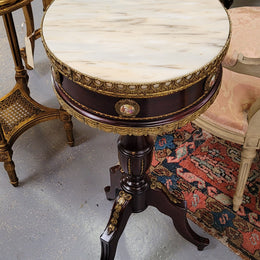 Elegant French louis XVI revival style round marble top side table with ceramic features and ormolu decoration. It is in good original detailed condition and has been sourced from France.