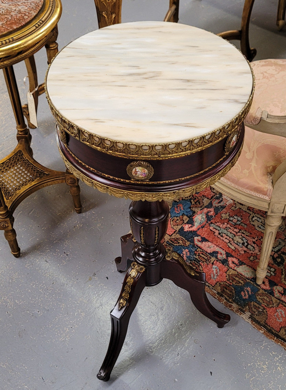 Elegant French louis XVI revival style round marble top side table with ceramic features and ormolu decoration. It is in good original detailed condition and has been sourced from France.