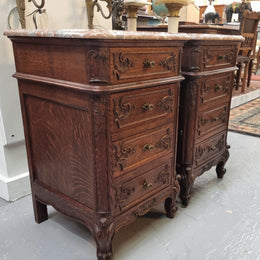 A pair of hard to find French Oak Louis XV style four drawer marble topped bedsides with attractive carvings. They are in good original detailed condition and have been sourced from France.