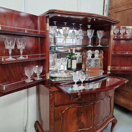 1950’s Chippendale Style Flame Mahogany Four door Bar. The top section has glass shelves and a mirrored pull out tray for storing glasses, decanters & serving etc. It also has a silver presentation plaque to the Mayor of Hawthorn 1958. The bottom section is for storage bottles etc. A stunning and practical piece.