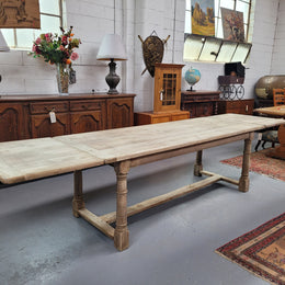 Beautilful raw solid oak French pedestal extension table. It has been sourced from France and is in good original detailed condition. When the table is fully extended it is 339 cm long and can comfortable seat 10-12 people. Features raw wood that could be used as is for a distressed look, or finished and waxed for a more refined look.