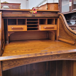Charming petite English Oak fitted roll top desk. It has a very lovely fitted interior and a drawer at the front ideal for a unit or apartment. Sourced locally and in good original detailed condition.