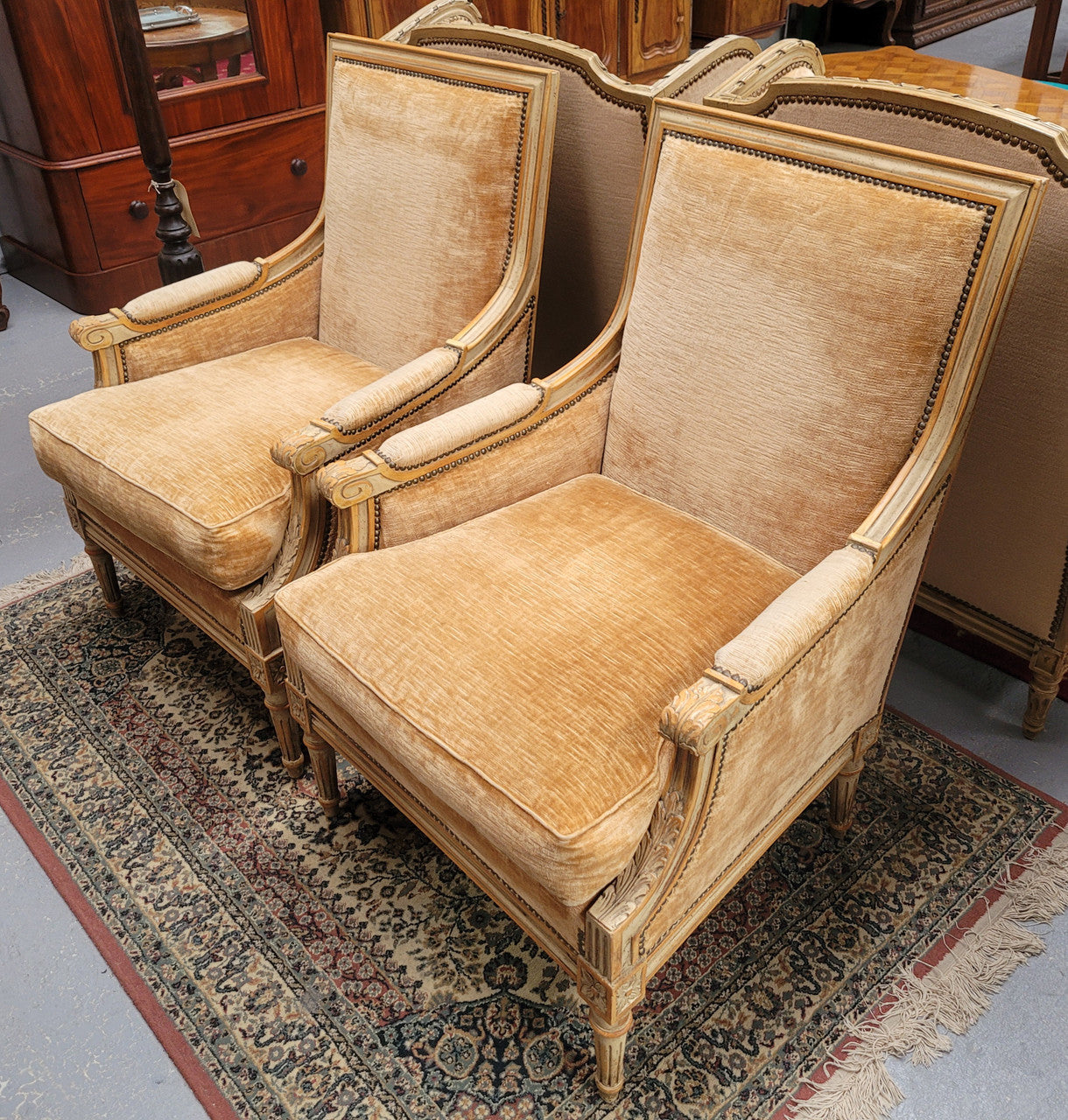 Pair of Louis XVI style painted arm chairs with carving & fluted legs. They have been sourced from France and the fabric is in good used original condition. Please view photos as they help form part of the description.