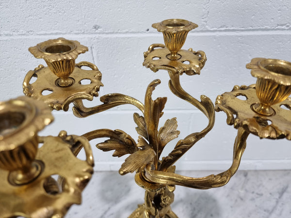 A pretty 19th Century French gilt bronze candelabra featuring a cherub. In good condition. Circa 1880.