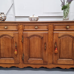 French Oak early 19th century three door buffet. It has a classic simple look and has three cupboards and three drawers. It is in good original detailed condition.