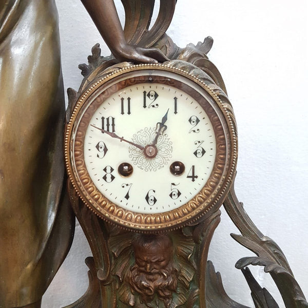 An elegant French Art Nouveau figural clock, with onyx marble depicting water and constructed from spelter. The clock is 61cm high and is in good original condition and in working order.