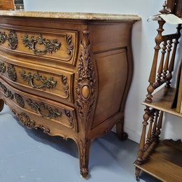 Impressive Louis XV style three drawer walnut commode. Ormolu handles and bevelled marble top complimenting detailed carving. In very good original detailed condition.