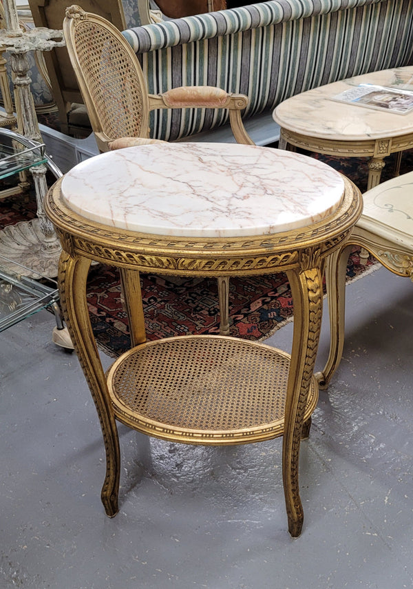 Stunning Louis XV style two tier marble topped gilt lamp/side table. It has been sourced from France and is in good original detailed condition.