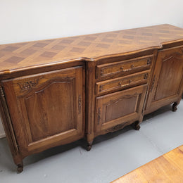 French Oak Louis XV style three door, two drawer, parquetry top sideboard. It has been sourced from France and is in good restored condition.