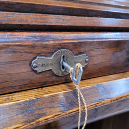 Charming petite English Oak fitted roll top desk. It has a very lovely fitted interior and a drawer at the front ideal for a unit or apartment. Sourced locally and in good original detailed condition.