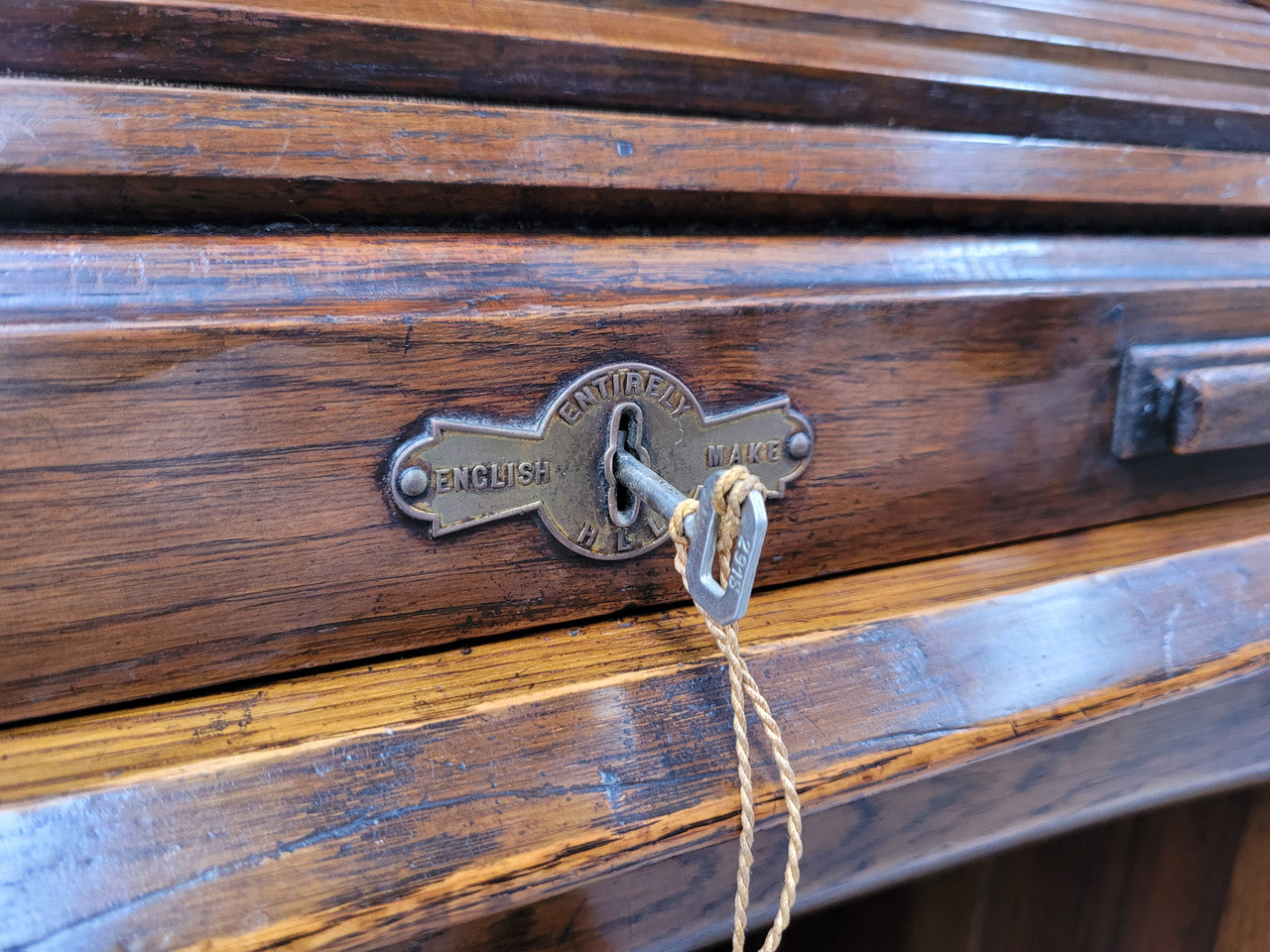 Charming petite English Oak fitted roll top desk. It has a very lovely fitted interior and a drawer at the front ideal for a unit or apartment. Sourced locally and in good original detailed condition.