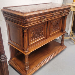 Stunning Henry II style French Walnut marble top buffet. It has a beautiful marble top and plenty of storage with two drawers, two doors with beautiful decorative carvings and an open shelf. It has been sourced from France and is in good original condition and has been detailed to a high standard.
