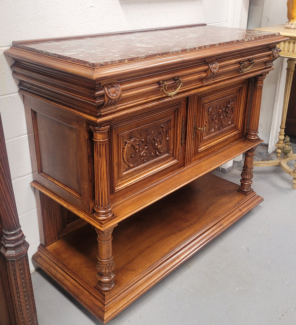Stunning Henry II style French Walnut marble top buffet. It has a beautiful marble top and plenty of storage with two drawers, two doors with beautiful decorative carvings and an open shelf. It has been sourced from France and is in good original condition and has been detailed to a high standard.