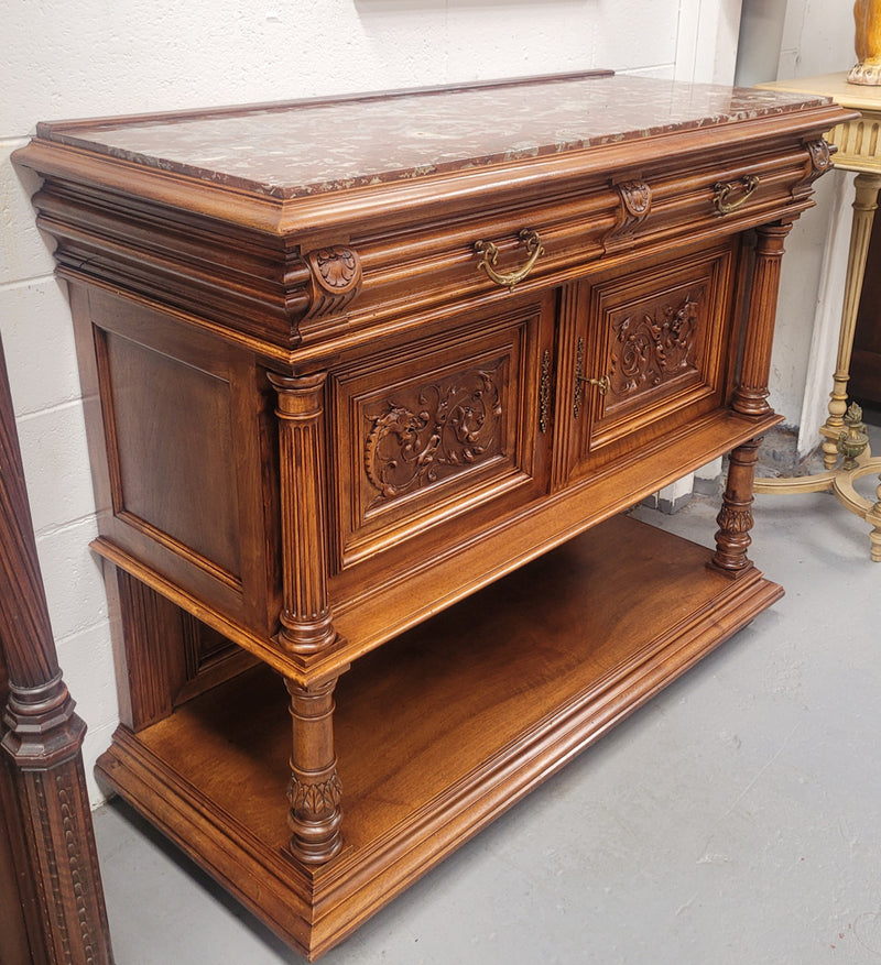 Stunning Henry II style French Walnut marble top buffet. It has a beautiful marble top and plenty of storage with two drawers, two doors with beautiful decorative carvings and an open shelf. It has been sourced from France and is in good original condition and has been detailed to a high standard.