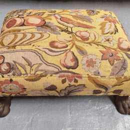 Lovely Upholstered Georgian footstool with feet. It has been sourced locally and is in good original condition.
