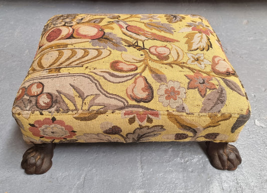 Lovely Upholstered Georgian footstool with feet. It has been sourced locally and is in good original condition.