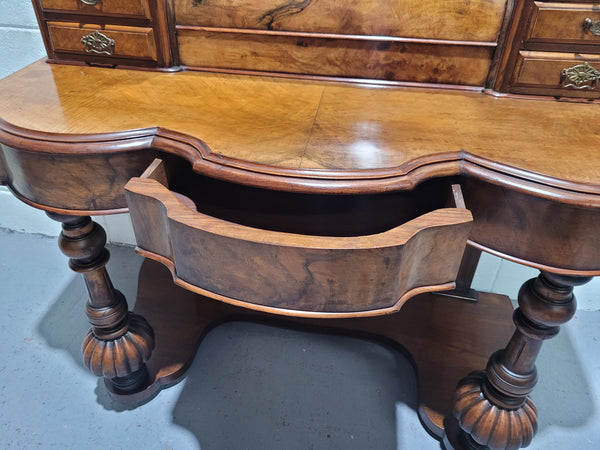 An elegant Victorian Figured Walnut dressing table with tilit mirror and a stunning fine Firgured Walnut serpentine shaped front. It has been sourced locally and is in good original detailed condition.