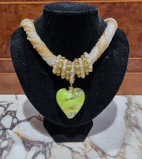 Hand Made Murano glass multi string small glass beads with medium glass beads and a large puff heart in neutral and green shades with gold. In original box.