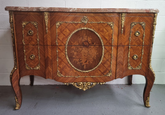 Stunning Louis XV style ormolu and marquetry marble top commode with two drawers. It has an amazing thick marble top and it is in good original detailed condition.