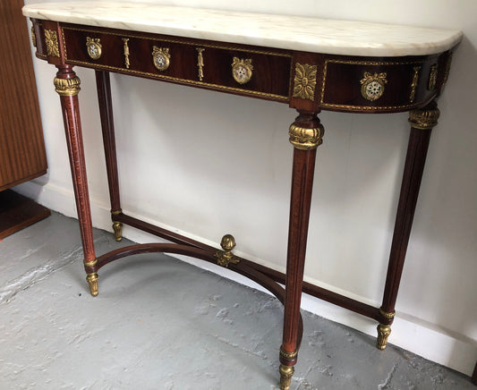 Narrow mahogany Louis XVI style console table with a marble top, ceramic inserts and gilt brass mounts.